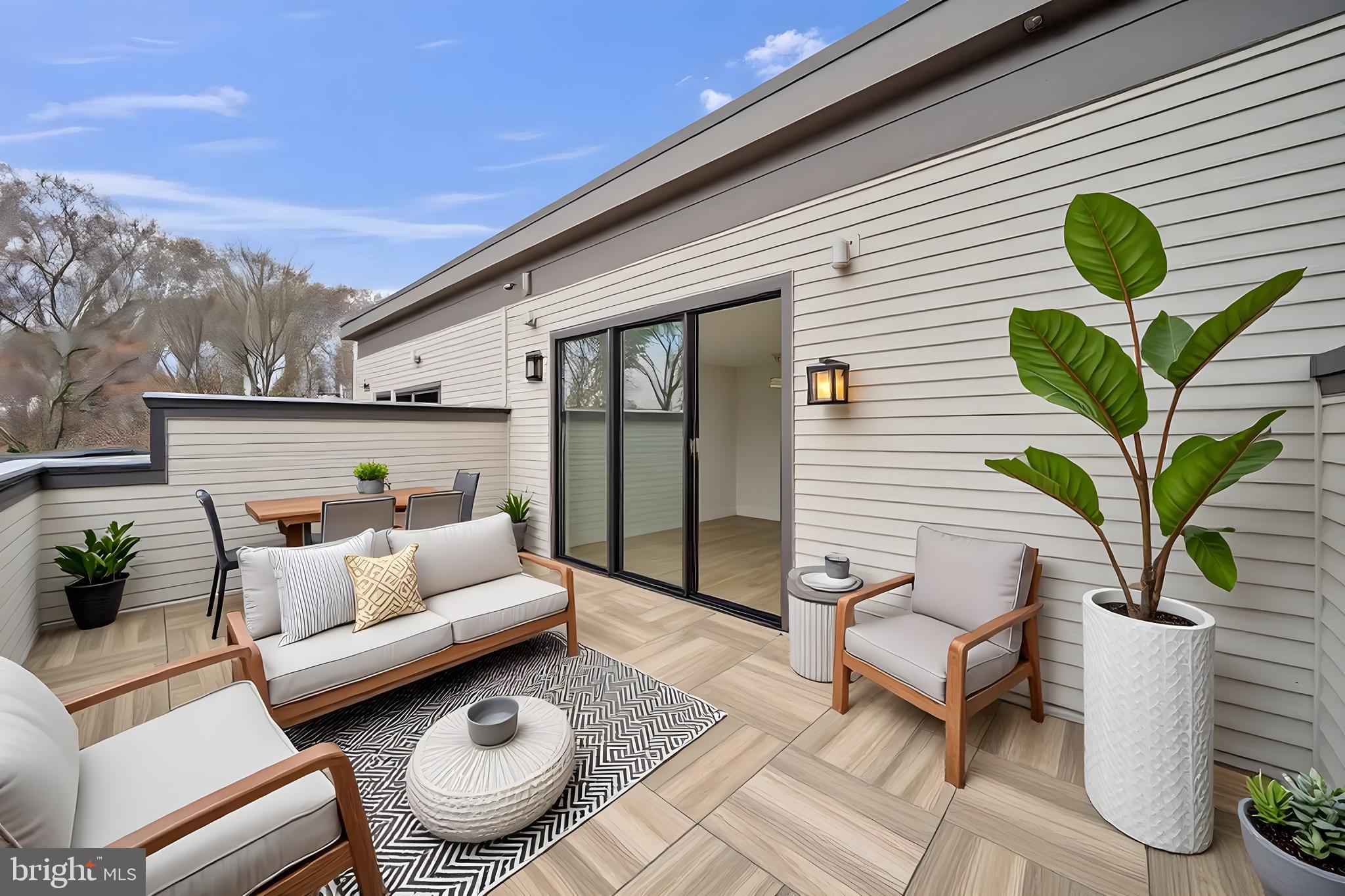 5420 Goshawk Alley Bethesda, MD 20816 - Photo 33 of 57 a balcony with furniture and a potted plant