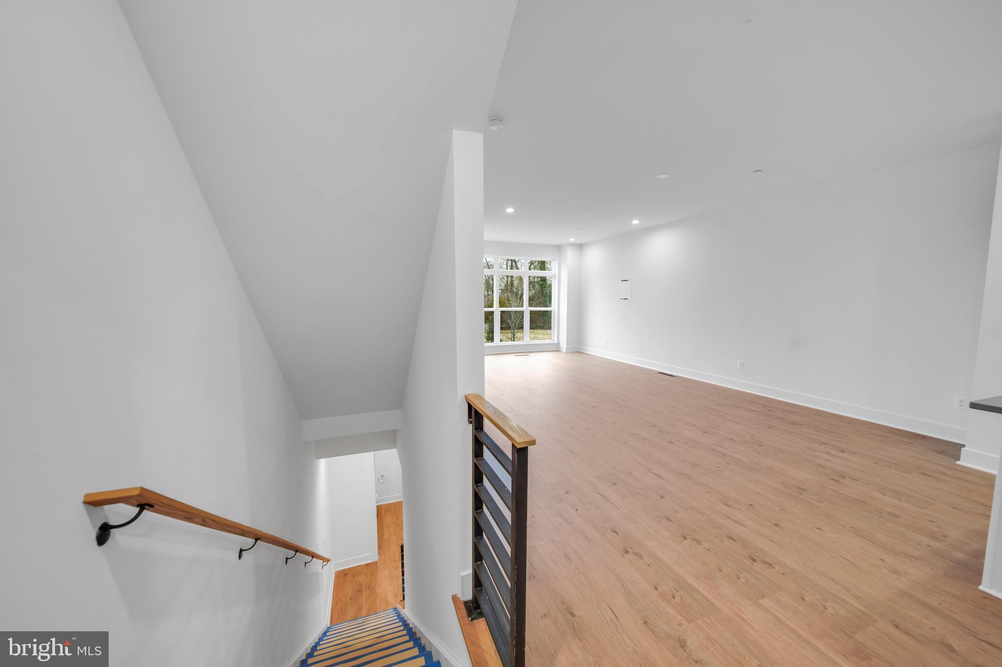 5420 Goshawk Alley Bethesda, MD 20816 - Photo 35 of 57 a view of an empty room with wooden floor and a window