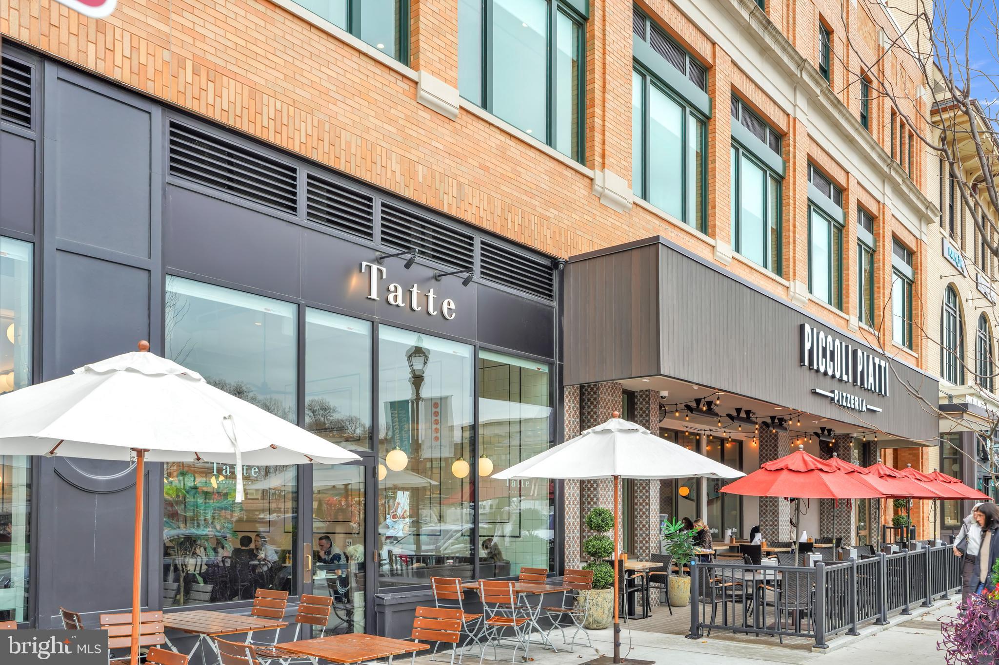 5420 Goshawk Alley Bethesda, MD 20816 - Photo 45 of 57 a patio with a table and chairs under an umbrella