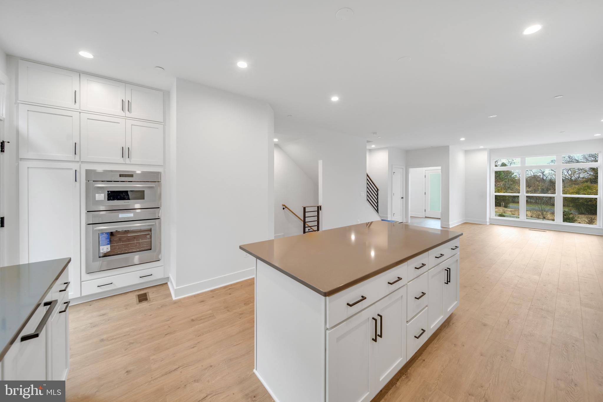 5420 Goshawk Alley Bethesda, MD 20816 - Photo 7 of 57 a kitchen with stainless steel appliances granite countertop a sink stove and refrigerator