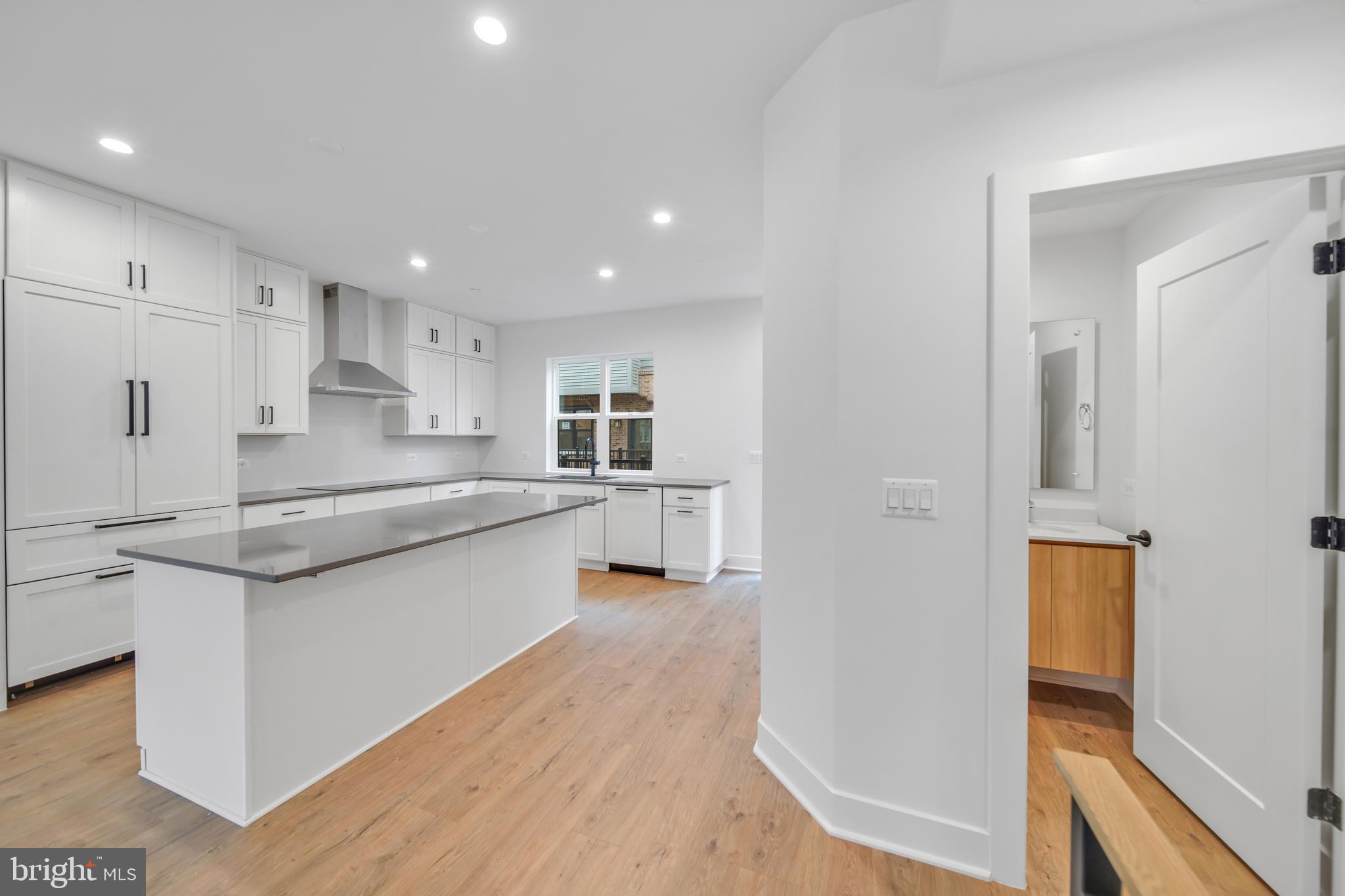 5420 Goshawk Alley Bethesda, MD 20816 - Photo 10 of 57 a large kitchen with a lot of counter space and wooden floor