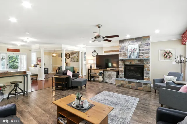a living room with furniture a flat screen tv and a fireplace