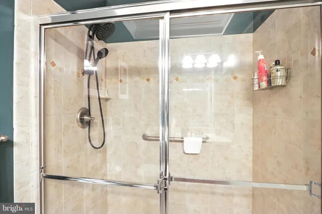 a bathroom with a glass shower door