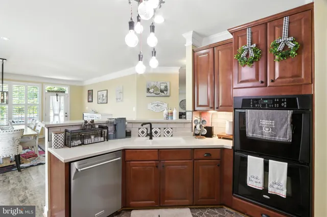 a kitchen with stainless steel appliances granite countertop a stove and cabinets