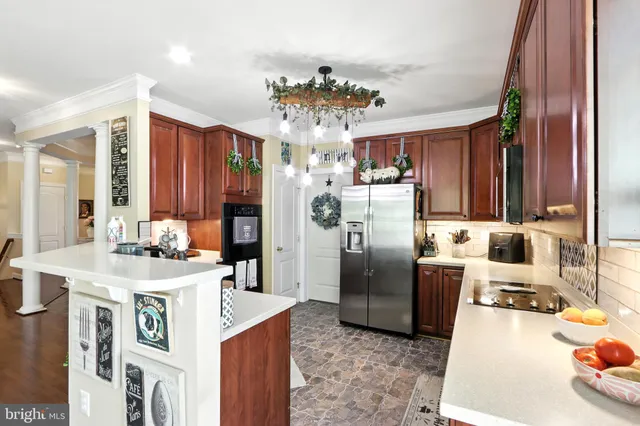 a kitchen with refrigerator and cabinets