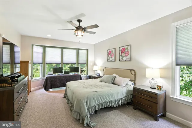 a spacious bedroom with a bed and a large window