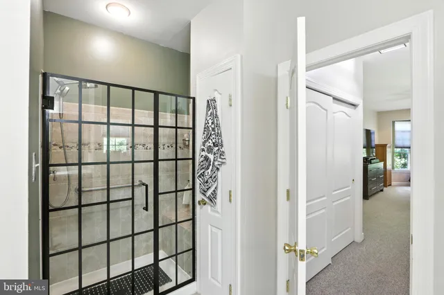 a bathroom with a tub a sink and mirror