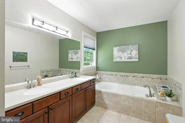 a bathroom with a granite countertop toilet a sink and a bathtub