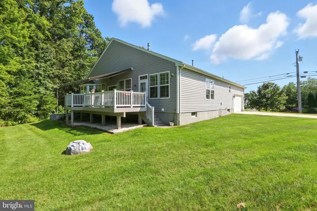 a view of backyard of house with green space