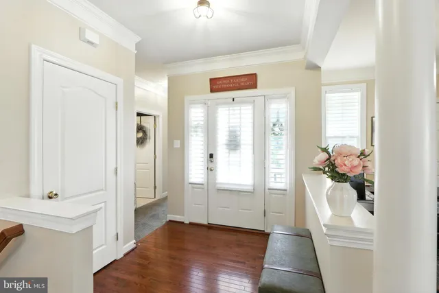 a hallway with white walls and wooden floor