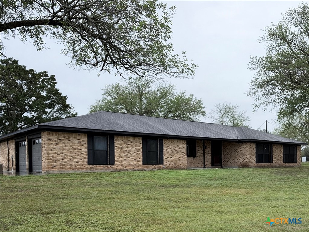 2243 Old Goliad Road Victoria, TX 77905 - Photo 1 of 47 a brick house with a yard