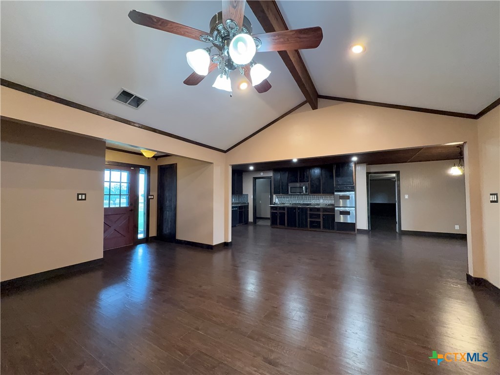 2243 Old Goliad Road Victoria, TX 77905 - Photo 14 of 47 an empty room with wooden floor chandelier and windows