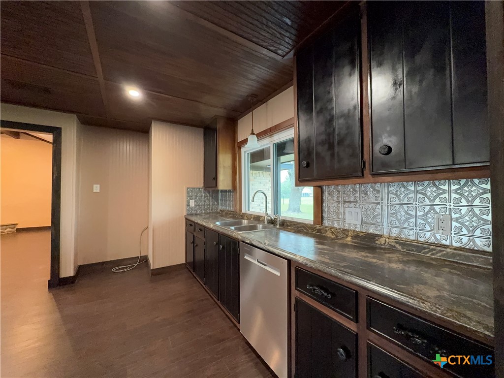 2243 Old Goliad Road Victoria, TX 77905 - Photo 16 of 47 a kitchen with granite countertop stainless steel appliances and wooden cabinets