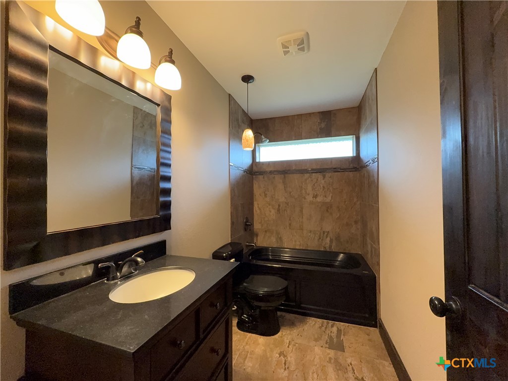 2243 Old Goliad Road Victoria, TX 77905 - Photo 23 of 47 a bathroom with a sink and a mirror