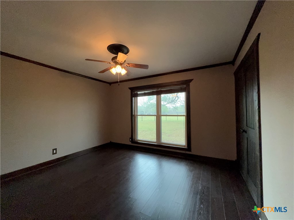 2243 Old Goliad Road Victoria, TX 77905 - Photo 24 of 47 wooden floor in an empty room with a window