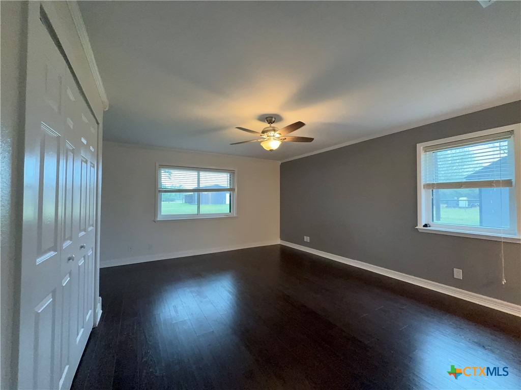 2243 Old Goliad Road Victoria, TX 77905 - Photo 25 of 47 a view of an empty room with wooden floor and a window