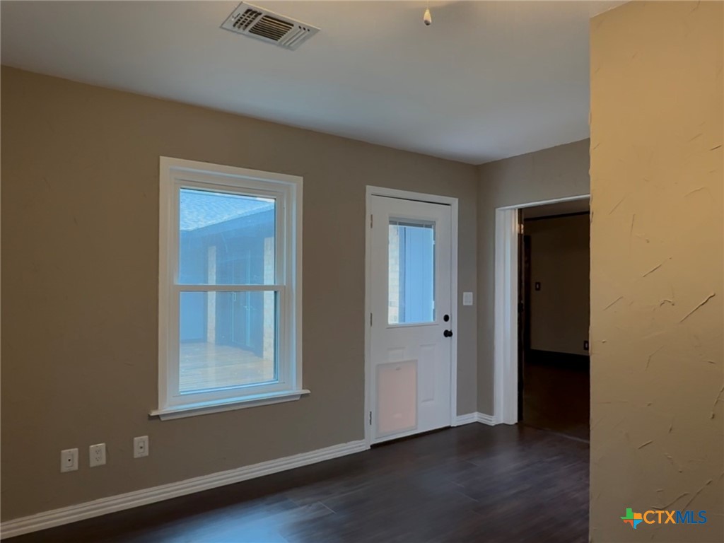 2243 Old Goliad Road Victoria, TX 77905 - Photo 34 of 47 an empty room with wooden floor closet and windows