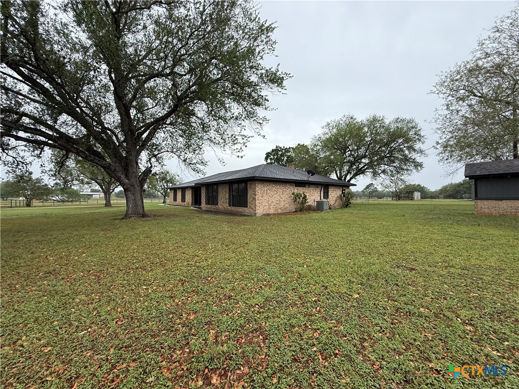 2243 Old Goliad Road Victoria, TX 77905 - Photo 5 of 47 a front view of a house with garden