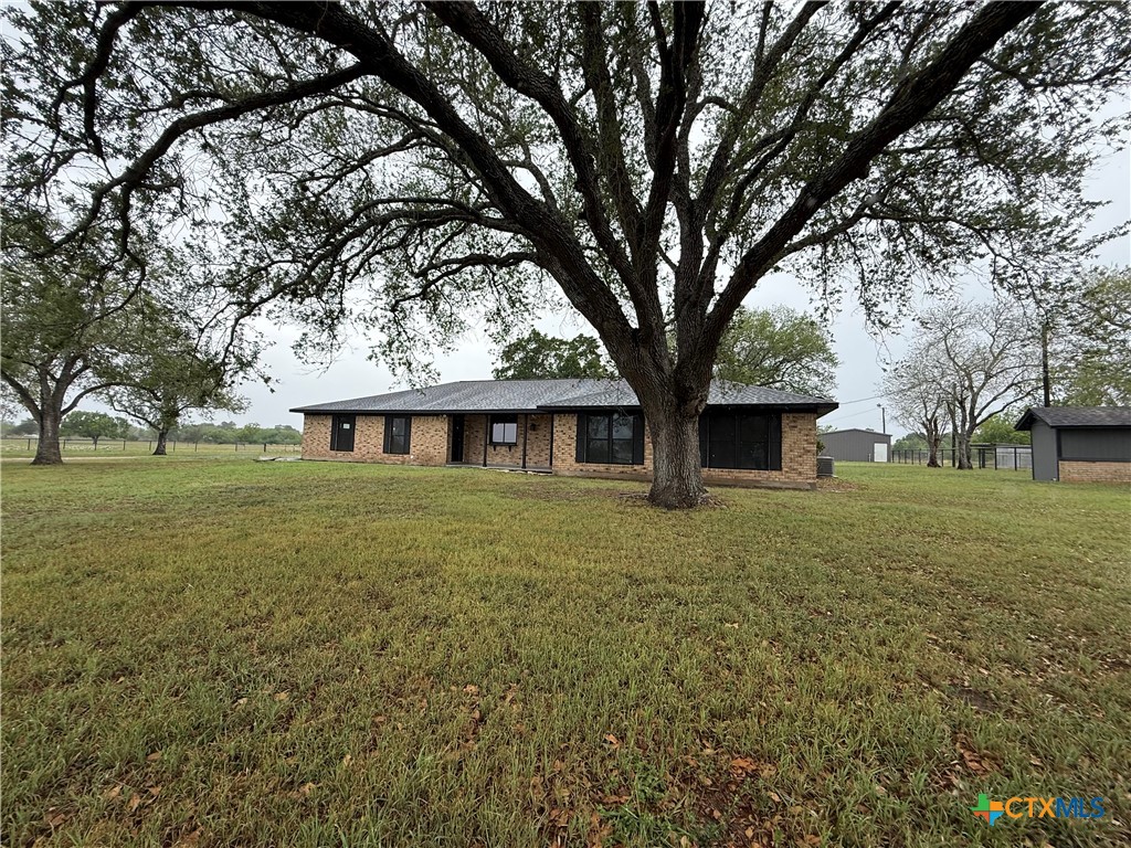 2243 Old Goliad Road Victoria, TX 77905 - Photo 6 of 47 a front view of a house with a garden