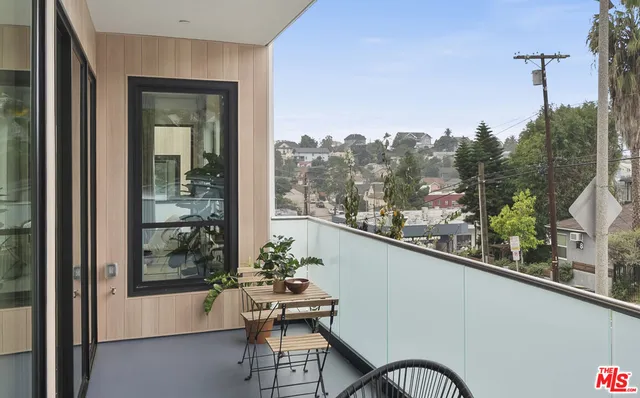 a balcony with table and chairs