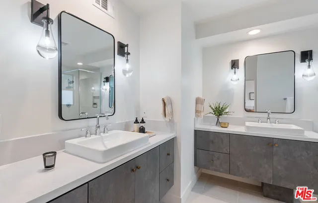 a bathroom with a double vanity sink mirror and double