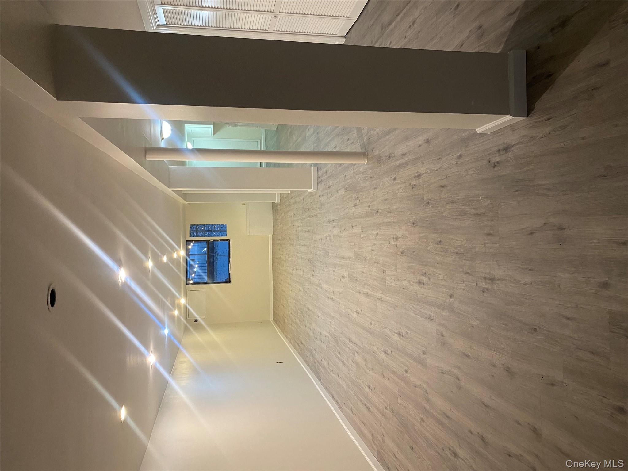 61-57 Eliot Avenue, Unit 1 Queens, NY 11379 - Photo 4 of 5 en empty room with wooden floor