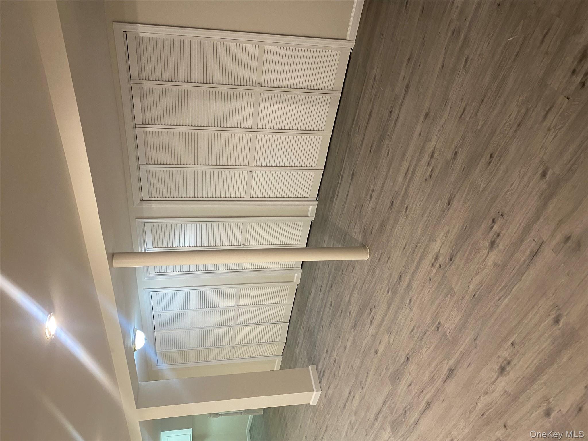 61-57 Eliot Avenue, Unit 1 Queens, NY 11379 - Photo 5 of 5 a view of an empty room with wooden floor