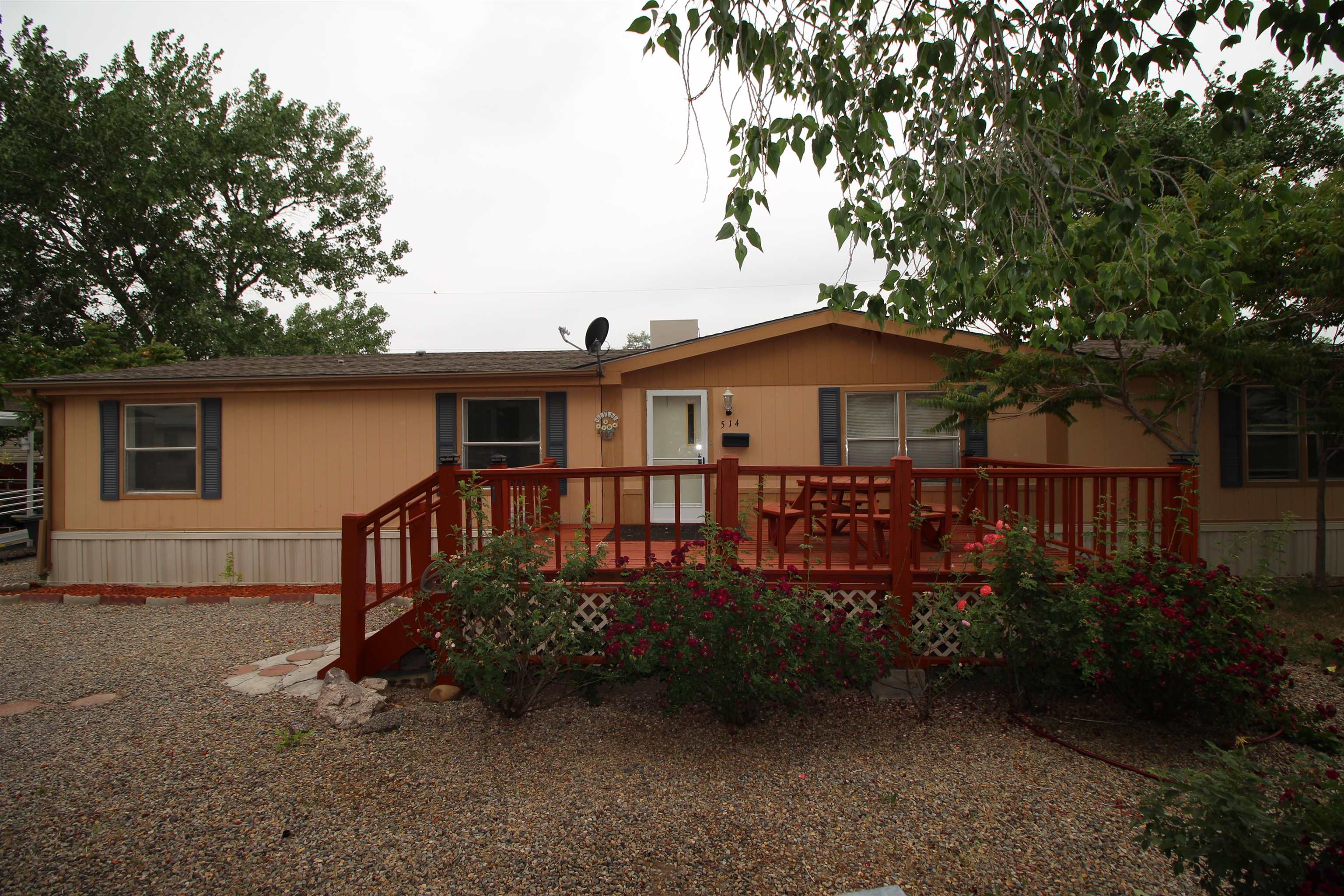 a view of a house with a small yard and wooden fence