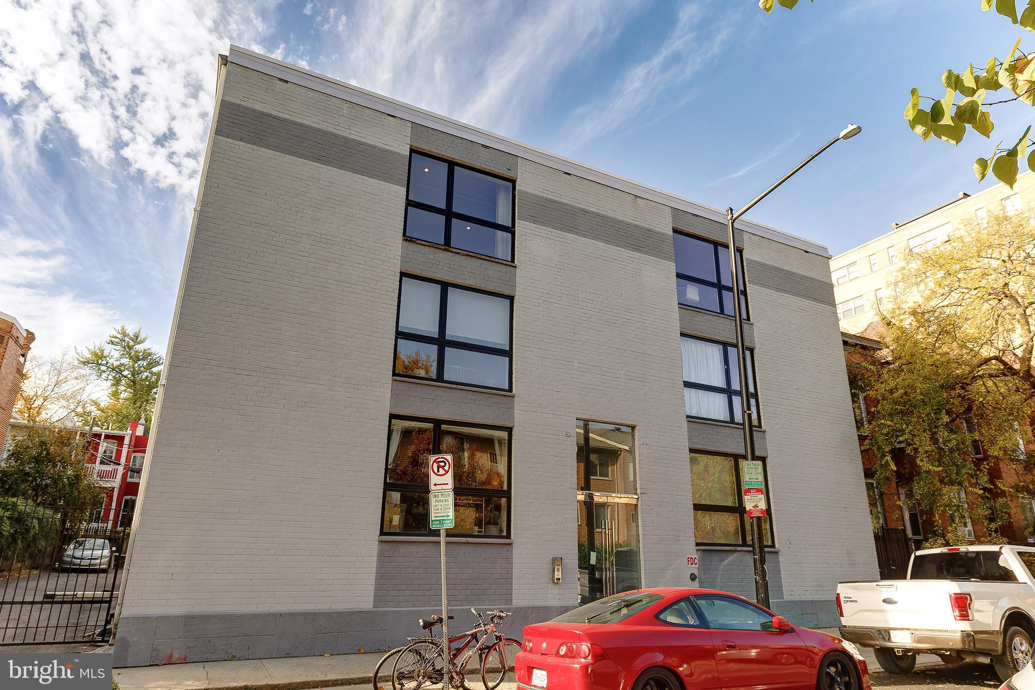 1514 Newton Street Northwest, Unit 301 Washington, DC 20010 - Photo 1 of 30 a front view of a house with a yard