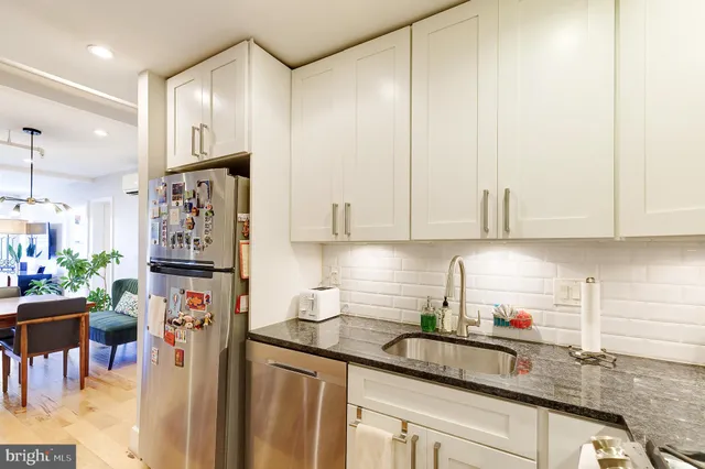 a kitchen with stainless steel appliances granite countertop a refrigerator sink and cabinets