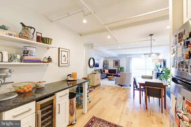 a living room with lots of furniture and kitchen view