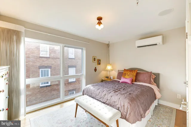 a bedroom with a large bed and a large window