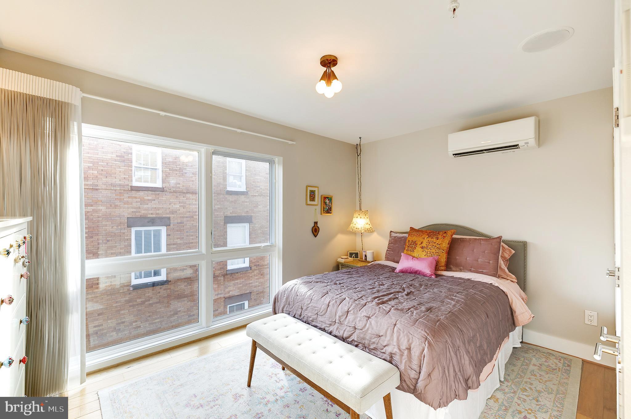 1514 Newton Street Northwest, Unit 301 Washington, DC 20010 - Photo 19 of 30 a bedroom with a large bed and a large window