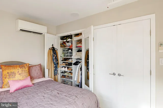 a bedroom with a bed and a walk in closet