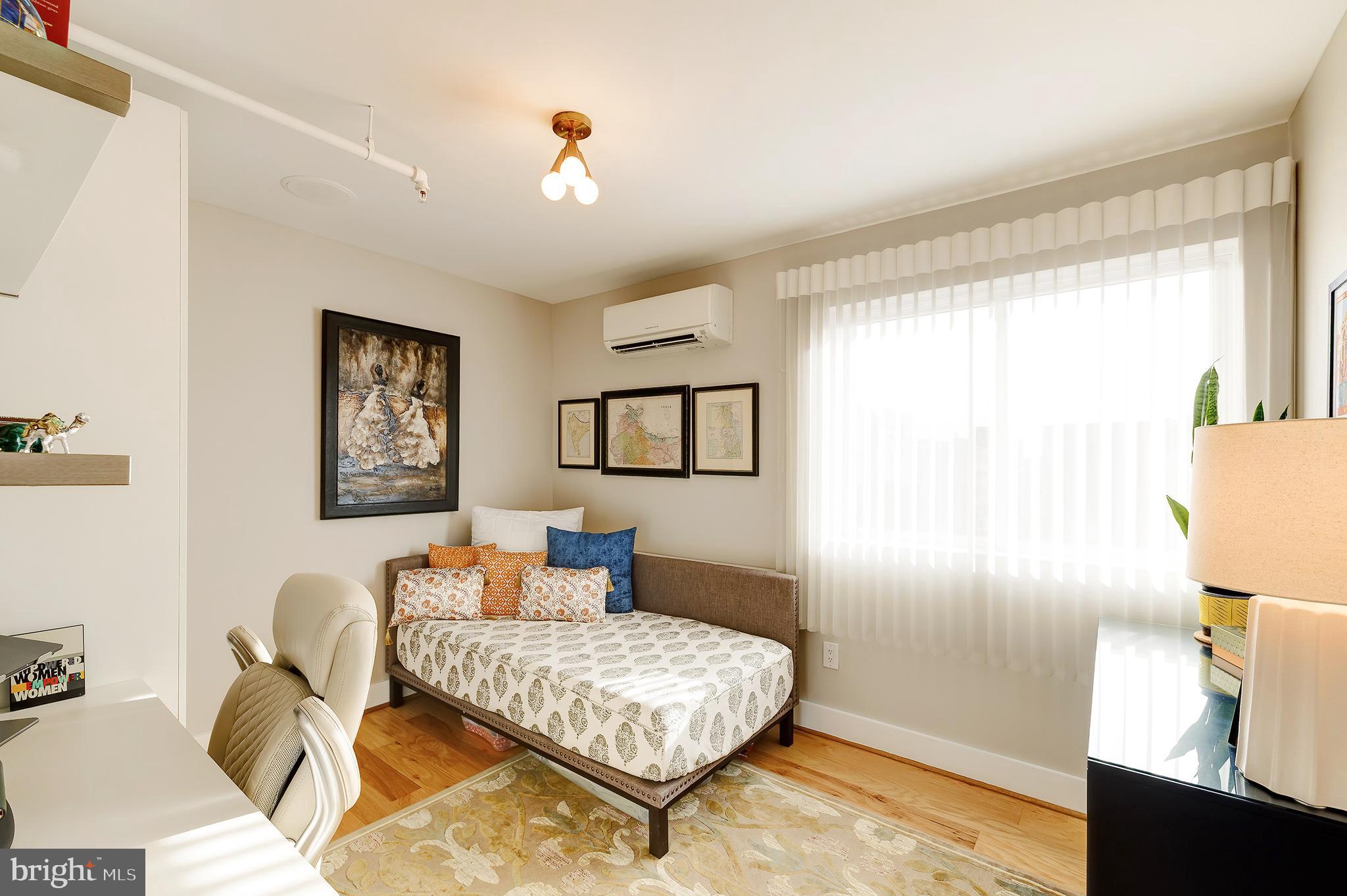 1514 Newton Street Northwest, Unit 301 Washington, DC 20010 - Photo 24 of 30 a bedroom with a bed and wooden floor