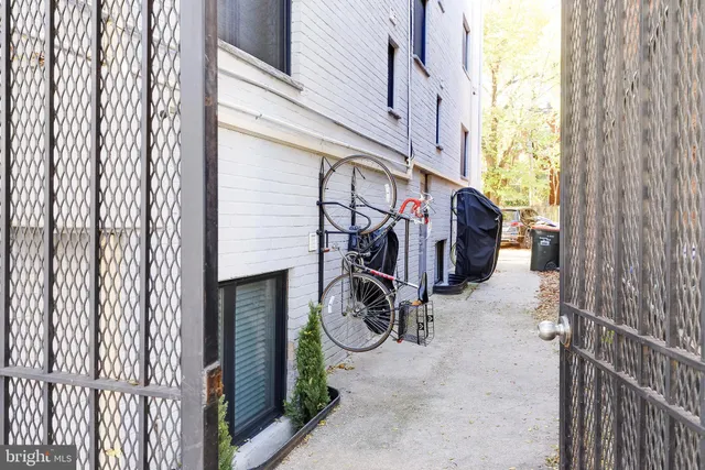 a view of bike storage next to a yard