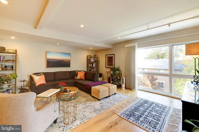 a living room with furniture and a floor to ceiling window