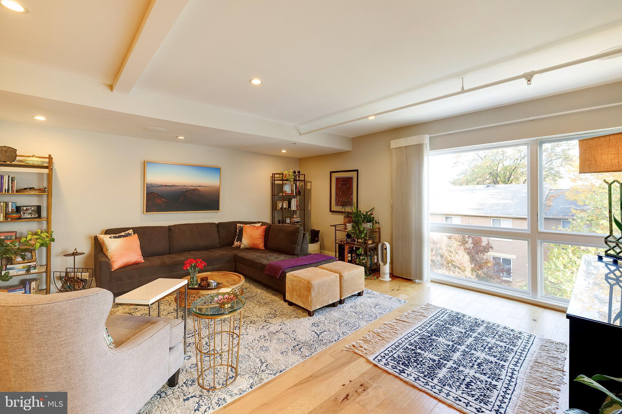 1514 Newton Street Northwest, Unit 301 Washington, DC 20010 - Photo 7 of 30 a living room with furniture and a floor to ceiling window