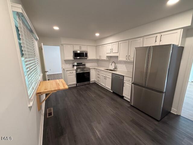 904 Brookwood Drive Raleigh, NC 27607 - Photo 8 of 12 a kitchen with stainless steel appliances granite countertop a refrigerator a stove a sink dishwasher and a refrigerator with wooden floor