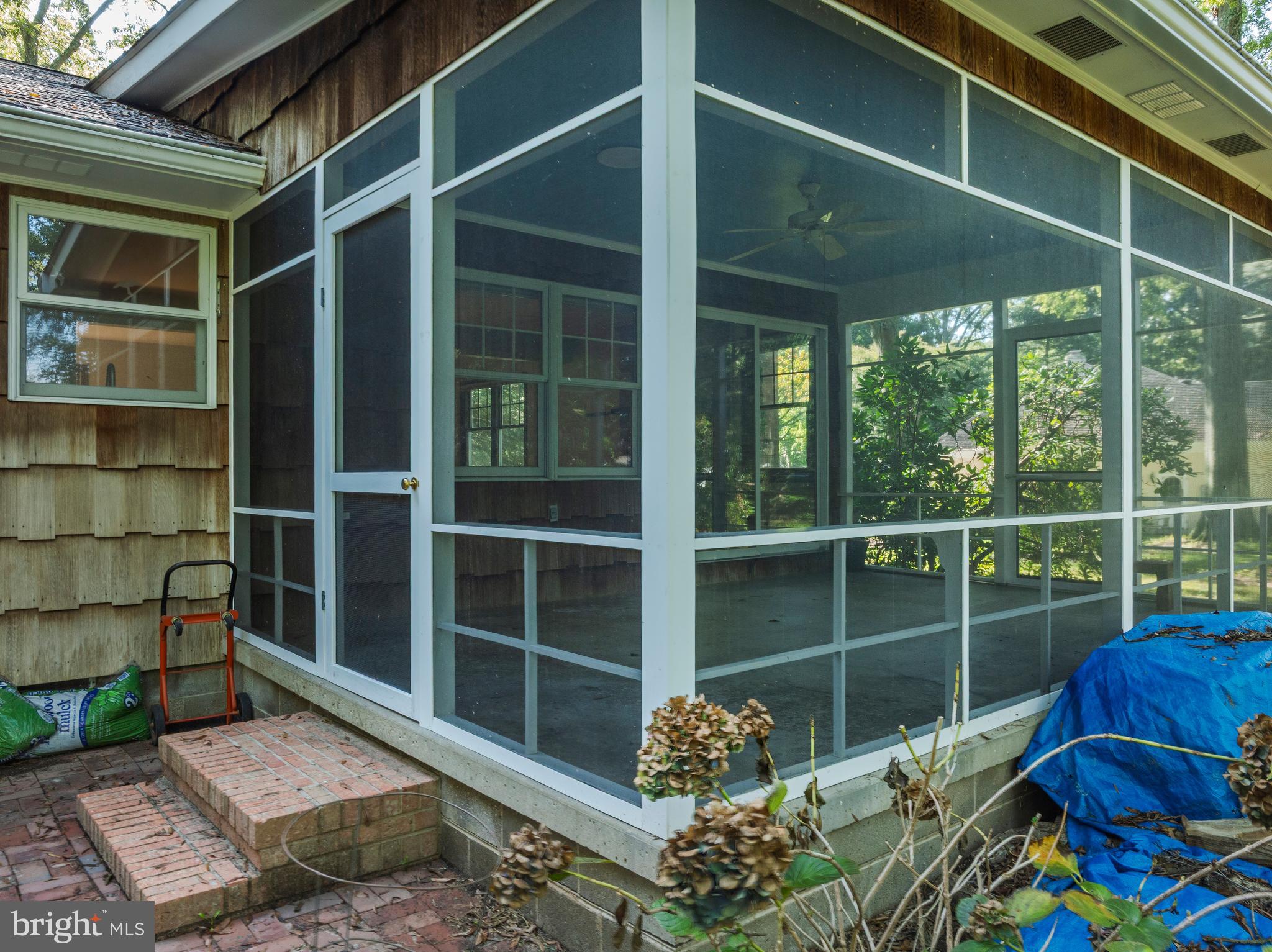108 Primrose Road Chestertown, MD 21620 - Photo 36 of 49 a view of a porch with a floor to ceiling window and wooden floor