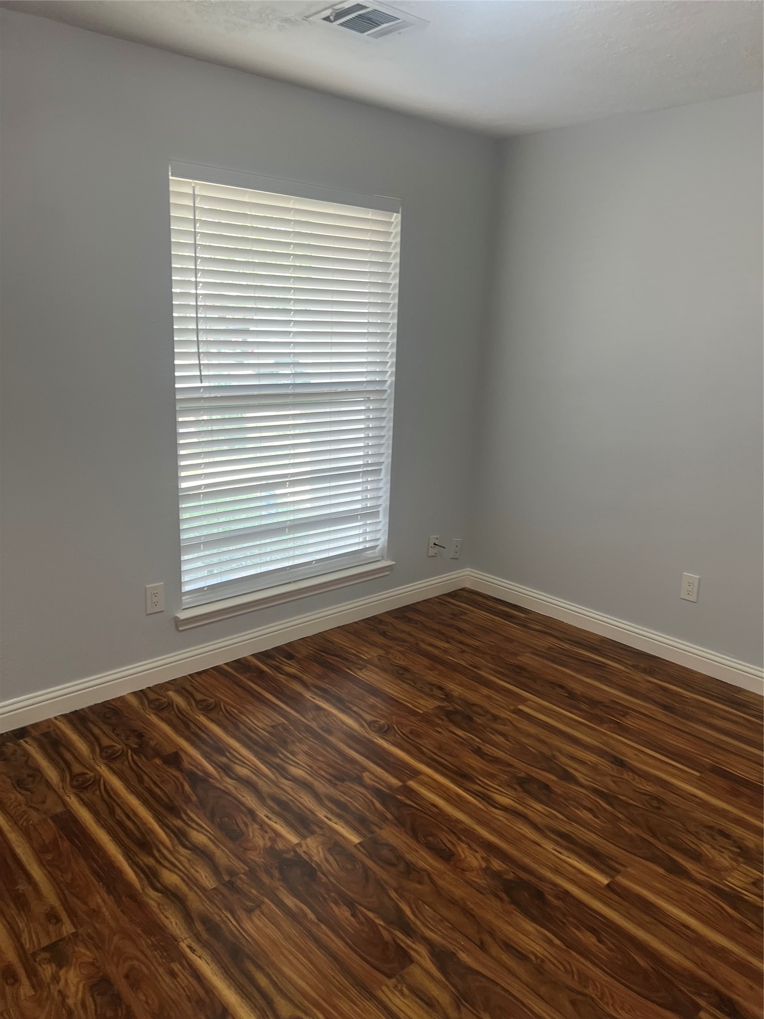 15303 Riverside Grove Drive Houston, TX 77083 - Photo 4 of 10 a view of a room with wooden floor and windows