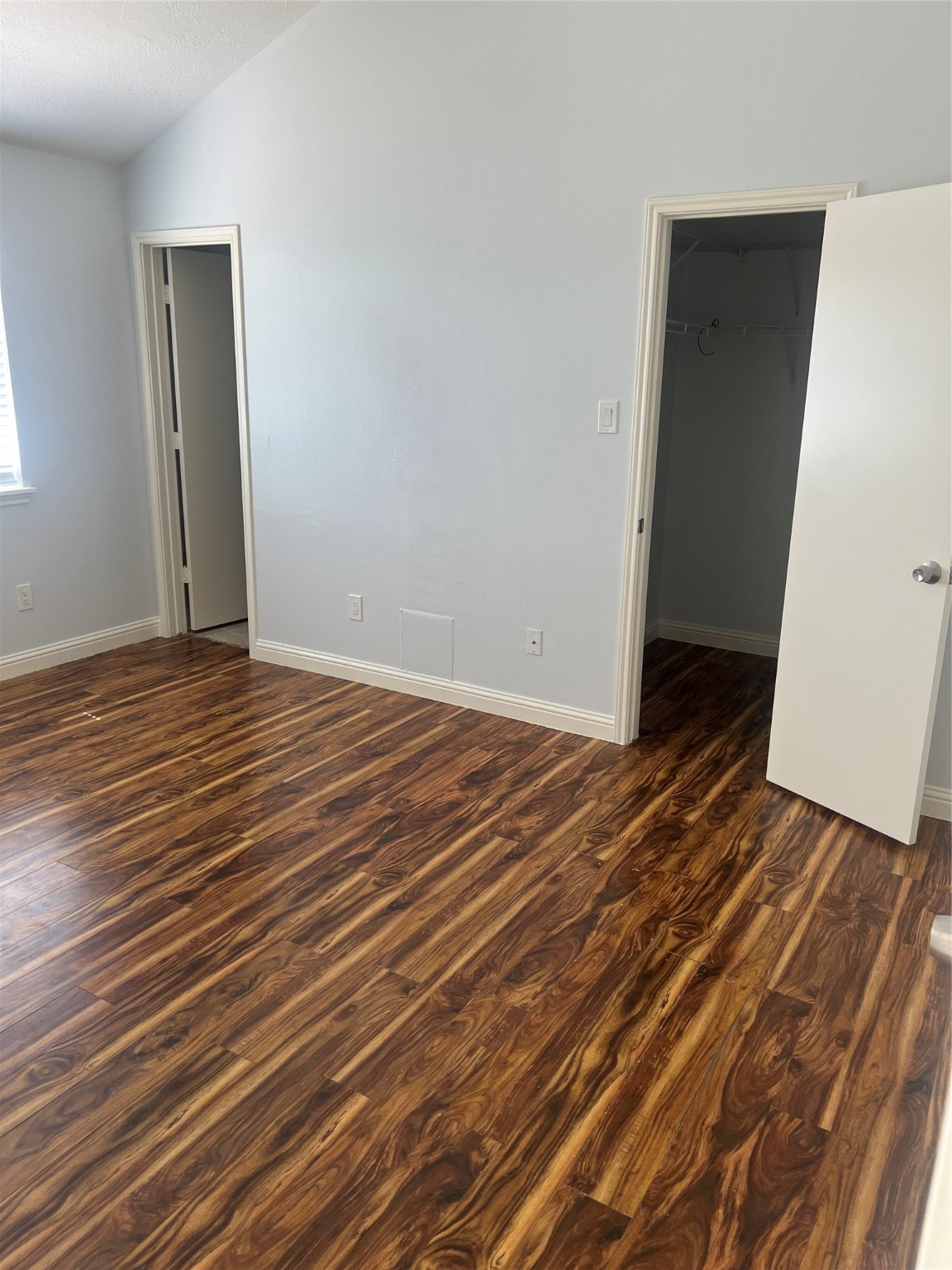 15303 Riverside Grove Drive Houston, TX 77083 - Photo 7 of 10 a view of an empty room with wooden floor