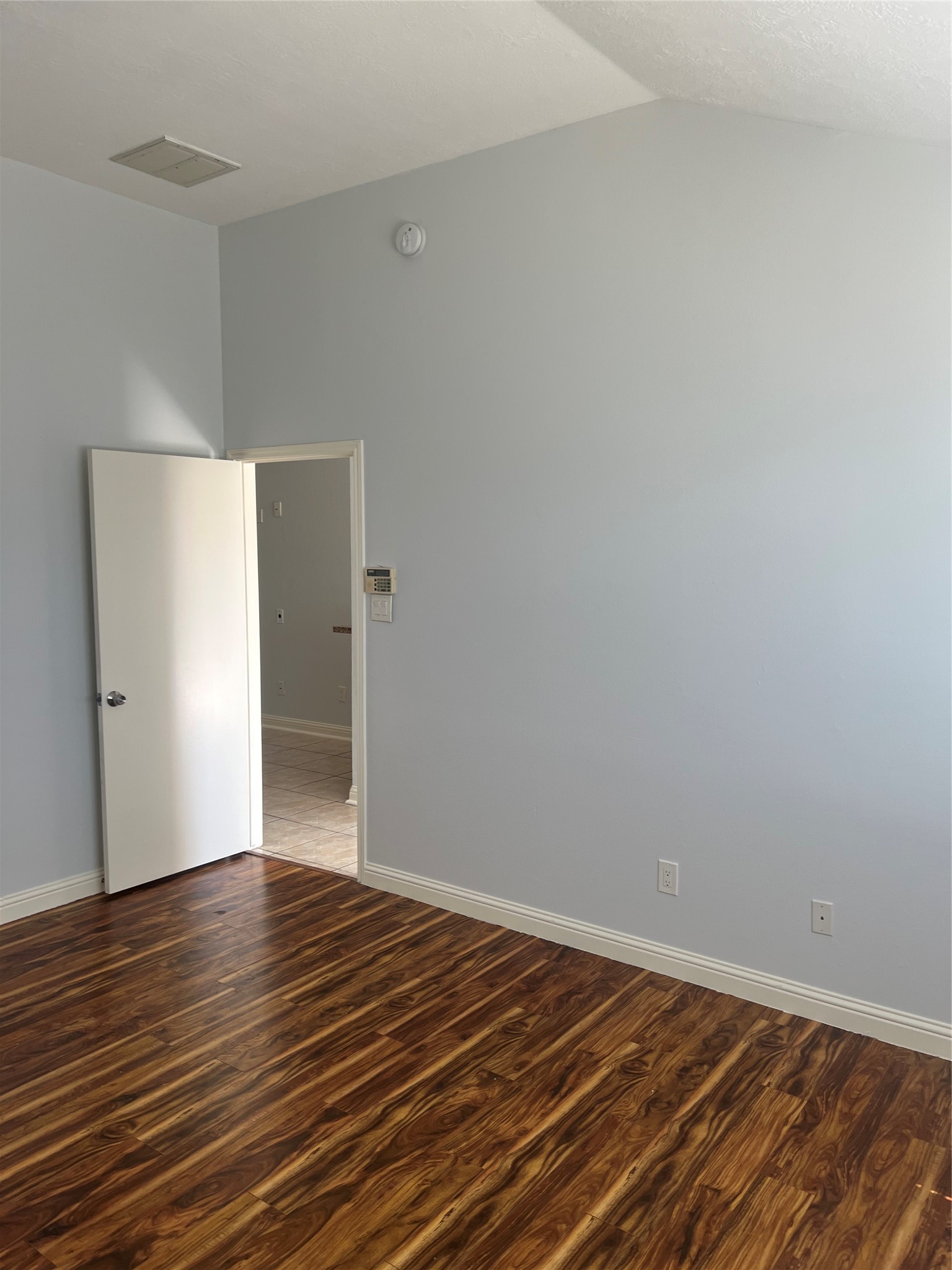 15303 Riverside Grove Drive Houston, TX 77083 - Photo 9 of 10 a view of an empty room with wooden floor
