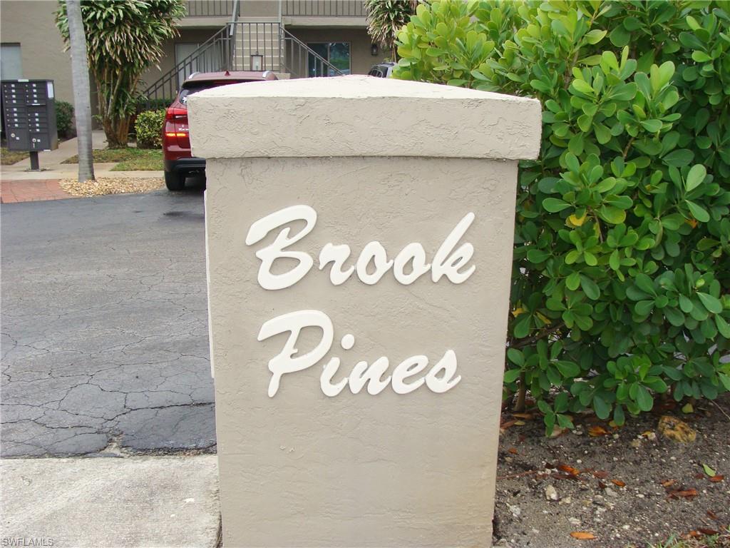 5693 Rattlesnake Hamm Road, Unit A204 Naples, FL 34113 - Photo 1 of 29 a sign that is on the side of a building