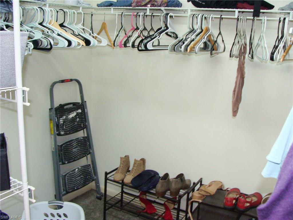 5693 Rattlesnake Hamm Road, Unit A204 Naples, FL 34113 - Photo 14 of 29 a view of a room with rack on the wall