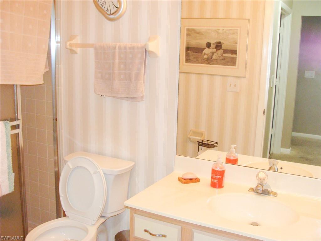 5693 Rattlesnake Hamm Road, Unit A204 Naples, FL 34113 - Photo 15 of 29 a bathroom with a sink and a mirror