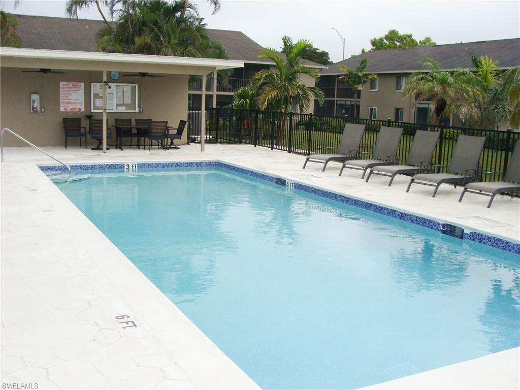 5693 Rattlesnake Hamm Road, Unit A204 Naples, FL 34113 - Photo 20 of 29 swimming pool view with a outdoor seating