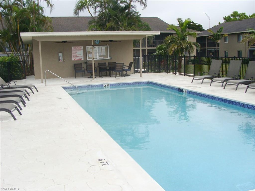 5693 Rattlesnake Hamm Road, Unit A204 Naples, FL 34113 - Photo 21 of 29 a swimming pool with outdoor seating