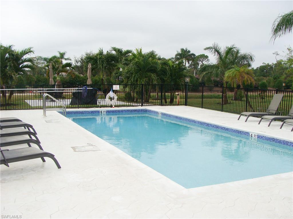 5693 Rattlesnake Hamm Road, Unit A204 Naples, FL 34113 - Photo 22 of 29 a view of a swimming pool with a patio