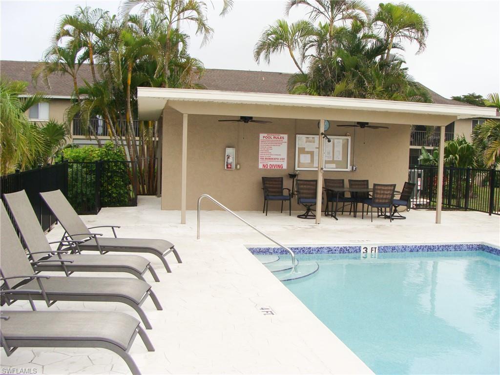 5693 Rattlesnake Hamm Road, Unit A204 Naples, FL 34113 - Photo 24 of 29 a view of a house with backyard porch and patio